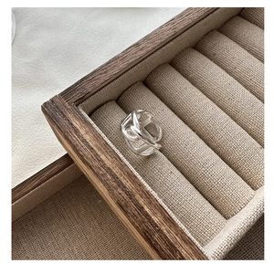 Macro shot of silver pig nose chain ring displayed in a premium wooden jewelry box