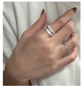 Macro view of S925 sterling silver double-layer wave ring with a brushed texture finish