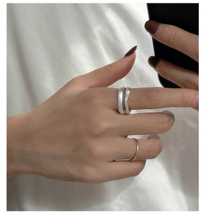 Detail of S925 sterling silver ring set featuring brushed texture and layered minimalist design