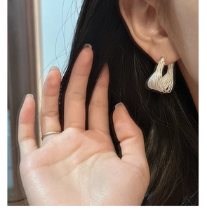 Detailed view of S925 sterling silver multi-strand curved earrings on a model