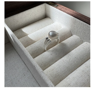 Detailed close-up of a large white pearl on an S925 silver ring with textured metal band