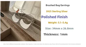Detailed view of large brushed S925 sterling silver crescent earrings in jewelry box