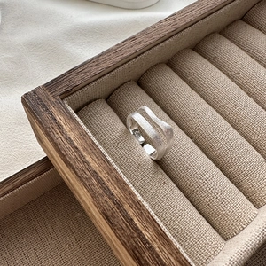 Dual-layer S925 sterling silver ring with brushed matte texture on wooden jewelry stand
