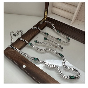 Detail of S925 silver Cuban link jewelry set with green emerald-cut zircon stones