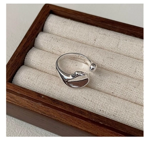 Macro shot of liquid lava irregular S925 sterling silver ring in a wood jewelry box