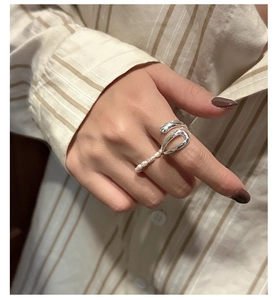 Detail of S925 sterling silver U-shaped ring with five micro pearls on a hand