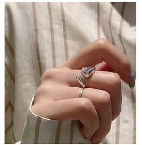 Close-up of S925 sterling silver irregular open ring with lava-style metallic texture