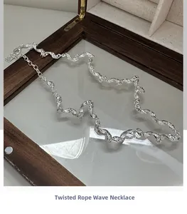 Detailed view of S925 silver wavy twisted rope necklace with metallic texture and lobster clasp