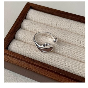 Detailed view of an irregular curved S925 silver ring with liquid metal texture design