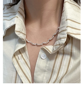 Detail of S925 sterling silver necklace with liquid metal texture on a female model
