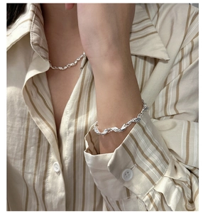Detail view of S925 sterling silver necklace and bracelet with liquid lava texture on model
