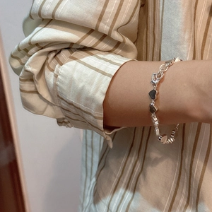 S925 sterling silver heart-shaped linked bracelet on a model wrist for daily wear