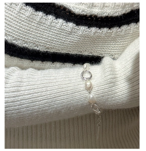 Close-up of S925 sterling silver bracelet with baroque pearls and textured metal rings
