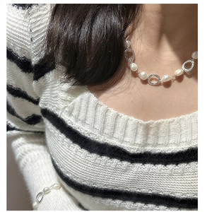 Close-up of S925 silver irregular circle links and freshwater pearl necklace on model