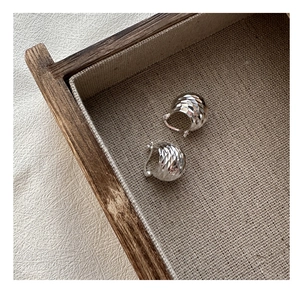 Detailed view of S925 sterling silver hoop earrings with faceted laser cut texture