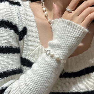 S925 sterling silver pearl bracelet with unique metal rings on a model wrist