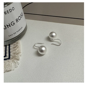 Detail of S925 sterling silver ball drop earrings with elegant matte brushed finish