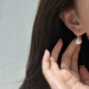 Minimalist S925 sterling silver frosted ball drop earrings worn by a model
