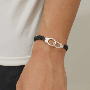 Adjustable black braided rope bracelet with silver handcuff charm for couples
