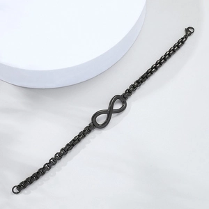 Detail of black infinity charm bracelet with box chain link and lobster clasp closure