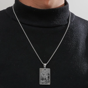 Men's silver stainless steel Tarot 'The Star' card pendant necklace on black sweater