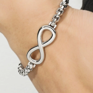Silver infinity symbol bracelet with box chain design on wrist for minimalist style