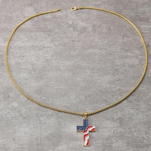 Detailed close-up of golden cross pendant with USA flag enamel and metallic chain link