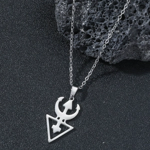 Silver stainless steel Prince love symbol pendant necklace on a dark textured background
