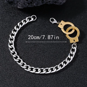 Detailed view of silver curb chain bracelet with gold handcuffs clasp, 20cm length detail