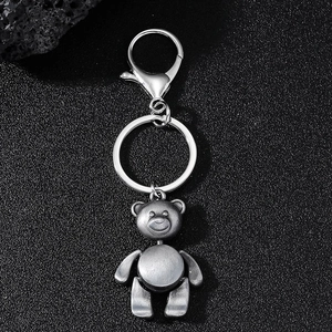 Creative vintage silver movable bear keychain with lobster clasp on black background