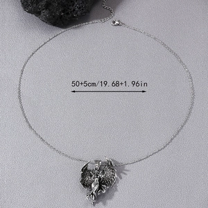 Detail of vintage angel wing pendant showing antique silver texture and 50+5cm chain length
