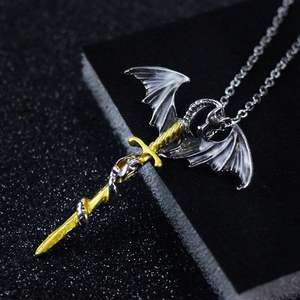 Gothic style silver dragon coiled around a golden sword pendant on a fine silver chain necklace
