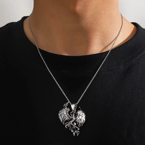Silver punk style pendant necklace with detailed winged dragon design on a male model
