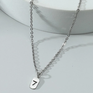 Detailed view of silver stainless steel number 7 pendant with polished O-chain texture