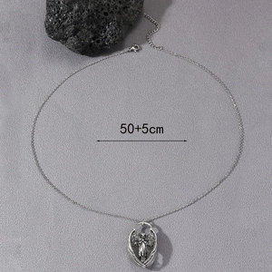 Vintage silver angel wings pendant necklace with detailed carving and cross chain