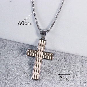 Detail of 60cm cross necklace with gold textured inlay and polished steel pendant