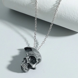 Vue détaillée du pendentif crâne gothique en argent avec fissures et dents creuses