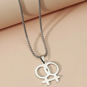 Macro detail of silver stainless steel interlocking double Venus symbol pendant necklace