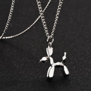 Pendentif chien ballon en argent poli pour hommes et femmes sur un fond noir élégant