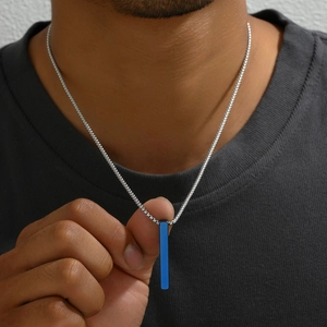 Close-up of minimalist rectangular bar pendant with blue inlay on silver steel chain
