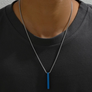 Close-up of vibrant blue rectangular pillar pendant with silver bead chain on a grey tee