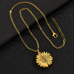 Macro shot of gold sunflower pendant showing intricate petal texture and opening detail