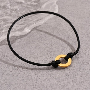 Minimalist black leather cord bracelet with polished gold stainless steel ring