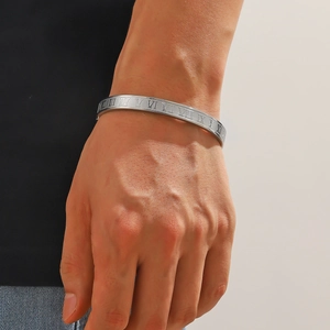 Men's silver stainless steel bangle with engraved Roman numerals in a modern open design