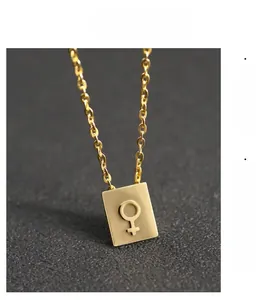 Close-up of golden stainless steel necklace featuring a square Venus symbol pendant