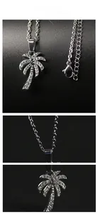 Detail showing silver palm tree pendant with sparkling zircons and delicate link chain