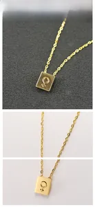 Detail of gold rectangular pendant with female symbol on a sleek O-chain necklace