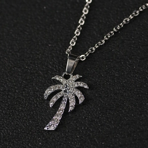 Tropical coconut palm tree necklace with sparkling zircons on a silver chain pendant