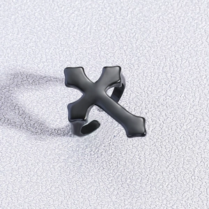 Close-up of a matte black cross ring with an adjustable open design in gothic style