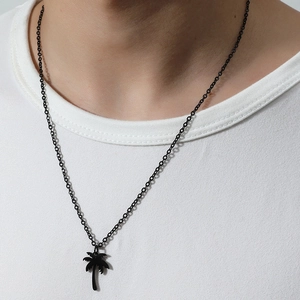 Minimalist black stainless steel coconut tree pendant necklace on model with white shirt